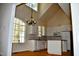 Bright, modern kitchen with white cabinets, an island, and large windows at 218 Keith Hills Rd, Lillington, NC 27546