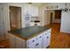 Open kitchen layout with an island, white cabinets, and views to other rooms at 218 Keith Hills Rd, Lillington, NC 27546