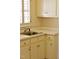 Bright kitchen featuring cream-colored cabinets, a stainless steel sink, and ample countertop space at 218 Keith Hills Rd, Lillington, NC 27546
