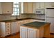 Bright kitchen featuring white cabinets, an island, and modern appliances at 218 Keith Hills Rd, Lillington, NC 27546