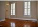 A bright living room featuring hardwood floors and plantation shutters at 218 Keith Hills Rd, Lillington, NC 27546