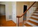 Stairway boasts hardwood floors, white trim, and a wood handrail at 218 Keith Hills Rd, Lillington, NC 27546