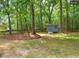 Spacious backyard with mature trees and a storage shed, offering ample outdoor space at 220 Barclay Rd, Chapel Hill, NC 27516