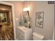 Bright bathroom with a vanity, mirror, and a toilet, alongside neutral walls at 220 Barclay Rd, Chapel Hill, NC 27516