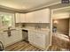 Modern kitchen featuring white cabinets, countertops, and a stainless steel dishwasher at 220 Barclay Rd, Chapel Hill, NC 27516