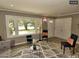 Bright living room featuring a large window, stylish seating, and hardwood floors at 220 Barclay Rd, Chapel Hill, NC 27516