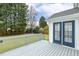 Back deck features gray wood, blue glass doors, and a view of the green backyard at 2310 Nutting Ln, Apex, NC 27523