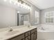 Bathroom featuring a double vanity, separate tub, and shower at 2310 Nutting Ln, Apex, NC 27523