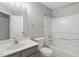 Well-lit bathroom featuring a vanity, toilet, and a shower-tub combo with white fixtures at 2310 Nutting Ln, Apex, NC 27523