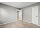 Neutral carpeted bedroom with bright lighting and white doors at 2310 Nutting Ln, Apex, NC 27523