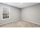 Bright bedroom featuring a large window providing natural light and neutral-toned walls at 2310 Nutting Ln, Apex, NC 27523