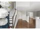 Bright foyer with beautiful hardwood floors, staircase, and views into adjacent living spaces at 2310 Nutting Ln, Apex, NC 27523