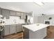 Spacious kitchen featuring gray cabinets, stainless appliances, white countertops and an island at 2310 Nutting Ln, Apex, NC 27523