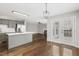 Open kitchen view with stainless appliances, white countertop island and seamless access to living room at 2310 Nutting Ln, Apex, NC 27523