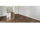 Neutral living room featuring hardwood floors and a bright window at 2310 Nutting Ln, Apex, NC 27523