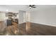 Open-concept living room and kitchen featuring modern stainless steel appliances and hardwood flooring at 2310 Nutting Ln, Apex, NC 27523
