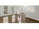 Bright living room featuring hardwood floors and a staircase at 2310 Nutting Ln, Apex, NC 27523
