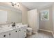 Bright bathroom features a marble countertop vanity and tiled floor at 251 W Moffitt Avenue, Liberty, NC 27298