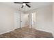 Neutral bedroom with wood-look floors, ceiling fan and double closet at 251 W Moffitt Avenue, Liberty, NC 27298