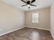 Spare bedroom with wood-look floors, neutral paint, ceiling fan and a window at 251 W Moffitt Avenue, Liberty, NC 27298