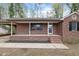Charming brick home with a covered front porch and a well-maintained yard at 251 W Moffitt Avenue, Liberty, NC 27298