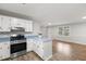 Well-lit kitchen with stainless steel appliances and lots of counter space at 251 W Moffitt Avenue, Liberty, NC 27298