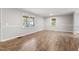 Bright living room with new wood floors and large windows to let the light shine in at 251 W Moffitt Avenue, Liberty, NC 27298