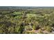 An aerial shot displays property boundaries surrounded by a dense forest and nearby pond at 2603 Brogden Rd, Creedmoor, NC 27522
