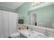 Updated bathroom with double sink vanity and a large mirror at 2603 Brogden Rd, Creedmoor, NC 27522
