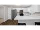 Modern kitchen featuring stainless steel appliances and white cabinetry with a countertop breakfast bar at 2603 Brogden Rd, Creedmoor, NC 27522