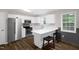 Modern kitchen featuring stainless steel appliances and white cabinetry with a countertop breakfast bar at 2603 Brogden Rd, Creedmoor, NC 27522