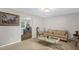 Inviting living room featuring neutral walls, carpet, and a stylish glass coffee table at 2603 Brogden Rd, Creedmoor, NC 27522
