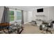 Bright office space featuring a glass top desk, neutral paint, carpet, a tv and window with natural light at 2603 Brogden Rd, Creedmoor, NC 27522