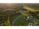 Expansive aerial view showcasing the property's vast land, surrounding trees, and distant views at 2905 Glendale Rd, Kenly, NC 27542