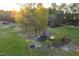 Aerial view of a large grassy property featuring a chicken coop and animal shelters with mature trees at 2905 Glendale Rd, Kenly, NC 27542