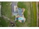 Bird's eye view of a well-manicured property featuring a house, outbuildings, and a sparkling pool at 2905 Glendale Rd, Kenly, NC 27542