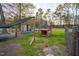 Large backyard featuring chicken coop, animal shelters and mature trees in a fenced in area at 2905 Glendale Rd, Kenly, NC 27542