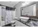 Bathroom featuring modern fixtures, a vessel sink, and black tile floors at 2905 Glendale Rd, Kenly, NC 27542