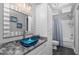 Bathroom with custom blue vessel sink, gray counters, and white cabinets at 2905 Glendale Rd, Kenly, NC 27542