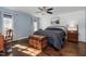 Charming bedroom features beautiful hardwood floors, a ceiling fan, and a large bed at 2905 Glendale Rd, Kenly, NC 27542