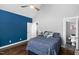 Bedroom featuring vaulted ceilings, blue accent wall, and wood floors at 2905 Glendale Rd, Kenly, NC 27542