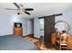 Cozy bedroom with ceiling fan, stylish vanity, and bathroom access through a sliding barn door at 2905 Glendale Rd, Kenly, NC 27542