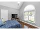 Bedroom featuring vaulted ceilings, large window, and wood floors at 2905 Glendale Rd, Kenly, NC 27542