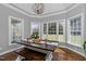 Dining area with hardwood floors, a modern chandelier and a view of the property at 2905 Glendale Rd, Kenly, NC 27542