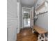 Welcoming entryway with shiplap walls, a wooden bench, and a view to the garage at 2905 Glendale Rd, Kenly, NC 27542