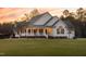 Well-maintained home with a charming porch, classic siding, and a neatly manicured lawn at 2905 Glendale Rd, Kenly, NC 27542