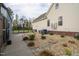 The home's exterior shows careful landscaping, with rocks and small bushes, and leads to a back door at 2905 Glendale Rd, Kenly, NC 27542