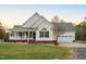 Well-maintained home with a charming porch, classic siding, and a neatly manicured lawn at 2905 Glendale Rd, Kenly, NC 27542