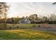 Single-story home with a welcoming front porch, nestled on a spacious lot with lush trees at 2905 Glendale Rd, Kenly, NC 27542