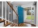 Entryway with hardwood floors, staircase, and vibrant blue front door at 2905 Glendale Rd, Kenly, NC 27542